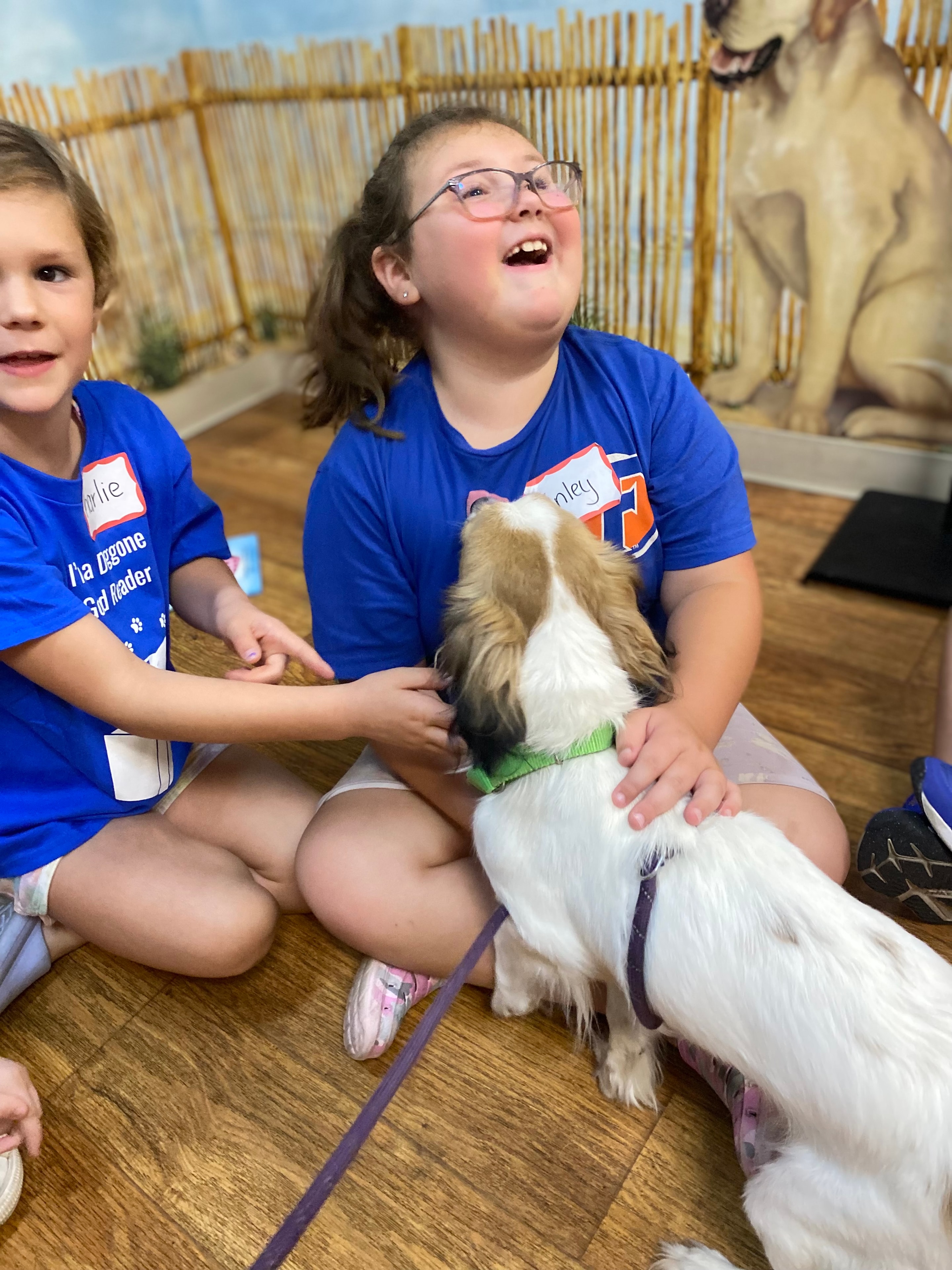 Children reading to a dog during Doggone Good Reading at HSMC.